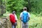 Backpackers hikers walking in forest