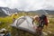 Backpackers are setting tent in mountains