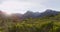 Backpackers Tramping On Footbridge By Trees And Mountains At Routeburn Track