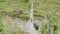 Backpackers walk on suspension bridge over river in Nepal. Manaslu circuit trek.