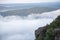 Backpacking woman on mountain - Hiker on rock above valley , watch over misty morning valley to bright morning Sun Tourist looking