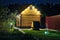 Backside of Illuminated Wooden House with Well in the Dusk