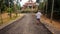 Backside Old Man Walks along Road to church in Vietnam