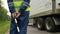 Backside view road police officer controls lorry driving past