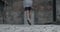 Backside view of teenager boy running and kicking, ball at old city street. Focus on ball. Concept of lifestyle and