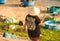 Backside Woman in Printed T-shirt Round Boats on Beach