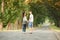 Backside of young couple walk on country road outdoor, romantic people concept, summer season