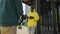 Backstage. Operator takes video of young african man in yellow headphones and yellow hoodie with phone in his hands