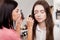 Backstage scene: Professional Make-up artist doing makeup for yo