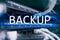 Backup button on modern server room background. Data loss prevention. System recovery