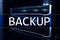 Backup button on modern server room background. Data loss prevention. System recovery