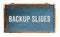 â€œBackup Slidesâ€ text word message written on a wide blue old grungy vintage wooden chalkboard or retro blackboard