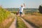 Backview of excited man with suitcase jumping on