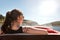 Backview from a woman in a boat, boating lake and blue sky