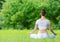 Backview of woman in lotus position zen gesturing