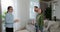 Backview of woman professional real estate agent make a apartment tour shows modern design for a young family couple