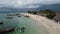 Backward flight over African island beach