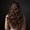 Backward front view of a beautiful long curly wavy haired brunette.