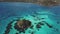 Backwards drone aerial view of a cay and island at the Caribbean