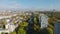 Backwards fly above multitrack railway line in city. Panoramic view of buildings and large park in metropolis. Berlin