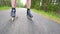 Backwards inline skating and braking on the asphalt. Close up view to move man legs and slow down. Easy backwards ride and slowing