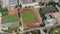 Backwards reveal of sports centrum. Aerial view of area for doing various sports, football pitch, tennis courts and