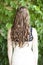 Backwards view of long curled brown hair with waterfall braid.
