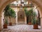 Backyard with arch, plants in pots, stairs and lantern. Patio decoration. Ancient courtyard background. Medieval architecture.