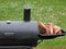 Backyard barbequing on a charcoal smoker