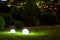 Backyard ground light garden with lantern electric lamp with sphere diffuser.