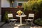 backyard patio with one white table, two chairs, and a single potted plant