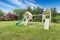 Backyard playground with swings, climbing wood panel