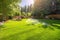 backyard with sprinkler system and lush green grass