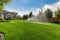 backyard with sprinkler system and lush green grass