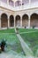 Backyard of unknown medieval monastery with arch and small statue. Small garden in catholic abbey, Camino de Santiago.