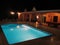 A backyard of a vacation house in dominican republic, blue pool and billiard.