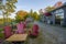 the backyard with a view of the autumn forest - an empty terrace without people, a patio with tables and muskoka chairs