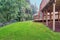 Backyard view of grey rambler house with upper and lower decks