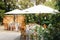 Backyard wedding reception - round tables with white tablecloths, vintage lanterns, roses and hyacinth,  and bentwood chairs