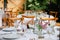 Backyard wedding reception - round tables with white tablecloths, vintage lanterns, roses and hyacinth,  and bentwood chairs