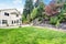 Backyard well kept garden with rocks desing, basketball hoop and volleyball net