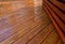 Backyard wooden deck floor boards with fresh brown stain