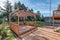 Backyard wooden deck pergola two story home in summer