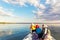 Bacl view two cute adorable little caucasian sibling together with mother wearing lifejacket vest having fun enjoy