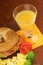 Bacon and cheese bagel with scrambled eggs and juice
