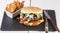 Bacon cheese bbq burger on wooden table with fries