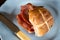 Bacon Cross Bun Served on Round Plate with Rusty Knife