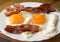 Bacon and eggs. Breakfast. Country style fried eggs with pork ham