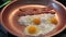 Bacon and eggs frying in a hot copper skillet