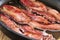 Bacon frying in a pan